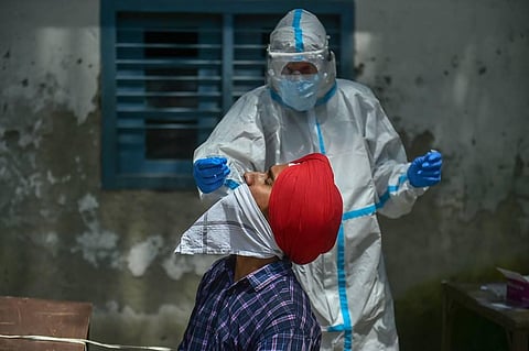 A health care worker collecting samples for COVID-19 testing. (Photo | PTI)