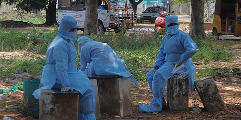Sanitation workers, who carried a dead body waiting outside ESI hospital, while doctors conduct coronavirus test on the corpse.(Representational Photo| Prasant Madugula, EPS)