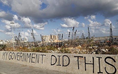 Words are written by Lebanese citizens in front of the scene of Tuesday's explosion that hit the seaport of Beirut, Lebanon, Sunday. (Photo | AP)