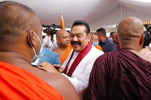 Sri Lanka’s former President Mahinda Rajapaksa, center, speaks with well wishing Buddhist monks after he was sworn in as the prime minister at Kelaniya Royal Buddhist temple in Colombo. (Photo | AP)