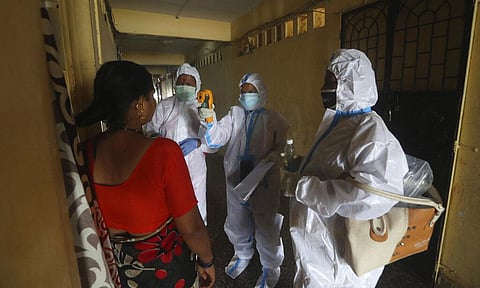 Health workers screen people for COVID-19 symptoms at a residential building in Dharavi , one of Asia's biggest slums, in Mumbai, India, Friday, Aug. 7, 2020. (Photo | AP)