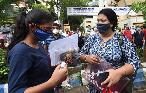 A female candidate with her guardian before appearing in JEE (Mains) amid COVID-19 pandemic. (Photo| PTI)