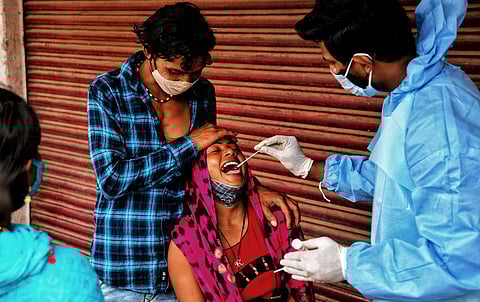 Health workers collecting swab near KR Market in Bengaluru. (Photo | Shriram BN, EPS)