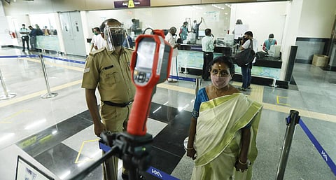 Kochi Metro reopened on Monday with the required Covid-19 protocol in place. A commuter under going thermal scanning at a metro station. (Photo | Arun Angela, EPS)