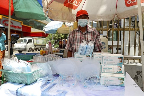 A vendor selling face masks and shields waits for customers at a roadside shop in Yangon, Myanmar, Thursday, Sept. 10, 2020. (Photo | AP)