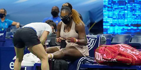 Serena Williams has her ankle taped by a trainer during a medical timeout during a semifinal match of the US Open against Victoria Azarenka. (Photo | AP)