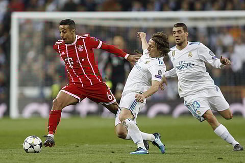 Bayern's Thiago, left, and Real Madrid's Luka Modric, Mateo Kovacic scuffle for the ball. (AP)