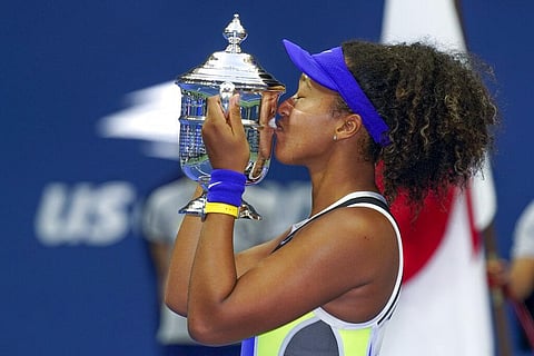 Naomi Osaka, of Japan, holds up the championship trophy after defeating Victoria Azarenka, of Belarus, in the women's singles final of the US Open tennis championships. (Photo | AP)