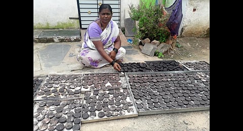 Parvatibai works with cakes of catechu spread out in front of her house | Express