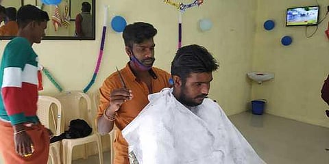 A man gets his hair cut at the public barber shop at Vattavada. (Photo| EPS)