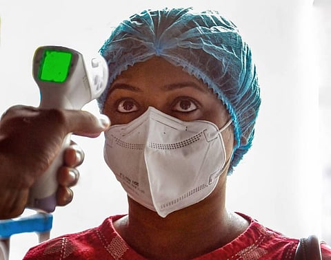 A passenger undergoes thermal screening at the entrance of Rabindra Sarobar Metro Station as Kolkata Metro resumed its services after 175 days owing to COVID-19 lockdown. (Photo | PTI)