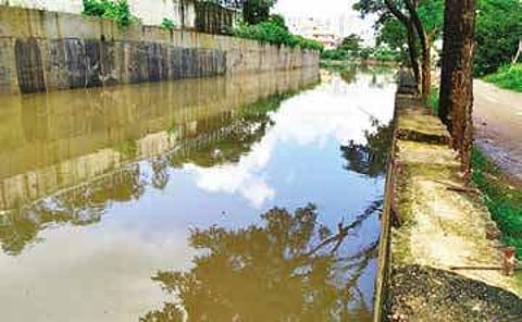 Hebbal residents are living in fear of their homes getting flooed, as the storm water drain in the area is filled to the brim | express