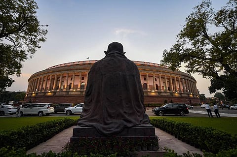 Mahatma Gandhi's statue in the backdrop of Parliament House on the opening day of Monsoon Session in New Delhi Monday Sept. 14 2020. (Photo | PTI)
