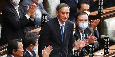 Yoshihide Suga stands up after being elected as Japan's new prime minister at parliament's lower house in Tokyo. (Photo | AP)