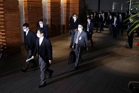 Newly appointed ministers, left, leave the official residence for the Imperial Palace to attend the attestation ceremony of the new cabinet by Prime Minister-elect Yoshihide Suga. (Photo | AP)
