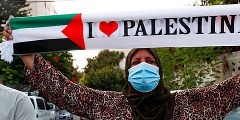 A woman during a protest against the UAE and Bahraini normalisation agreement with Israel, in front of the office of the UN Special Coordinator for the Middle East Peace Process office in Gaza City. (