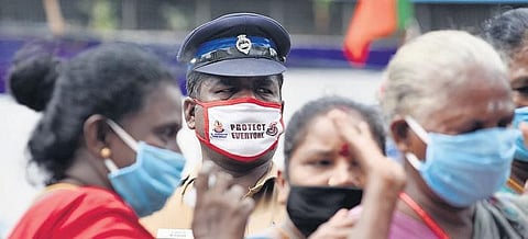 A policeman donning face mask with message ‘Protect Everyone’ to spread Covid-19 awareness, near Ice House in Chennai | R Satish Babu