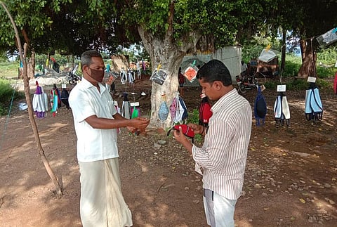 Kalla Ratna awardee Kondalpali Veerabhadraiah Bhagavat selss masks due to no stage plays during covid pandemic times in Kadapa on Thursday. (Photo | EPS)