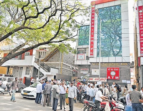 Account holders of Sri Guru Raghavendra Bank wait outside the office in Bengaluru on Monday (File photo) | Meghana Sastry