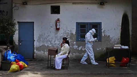 A health worker returns after taking a nasal swab sample to test for COVID-19 in New Delhi, India, Tuesday, Sept. 1, 2020. (Photo | AP)