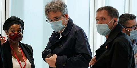 Satirical newspaper Charlie Hebdo's chief editor, Laurent Sourisseau, known as Riss (C)Â arrives at the courtroom for the opening of the 2015 attacks trial in Paris. (Photo | AP)