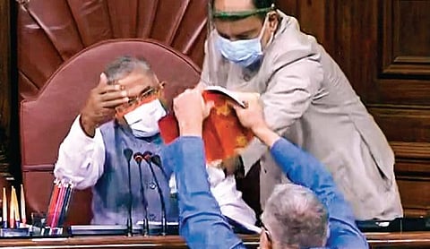 Trinamool Congress MP Derek O’Brien shows the rule book to Rajya Sabha dy chairman Harivansh Narayan Singh in the Parliament House on Sunday. (Photo | PTI)