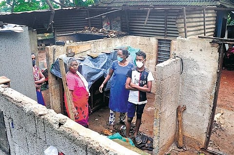 Omana Rajan (in blue top) shifting her belongings from her damaged house in Edathala with the help of family members | A Sanesh