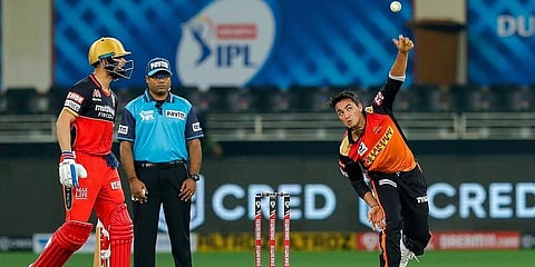 Sunrisers Hyderabad's Abhishek Sharma bowls as Virat Kohli watches. (Photo | PTI)