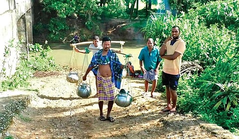 Residents of K Sitapur village carrying water collected from a tube well near the village.