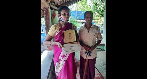 Mary Sebastian with the citation and cheque