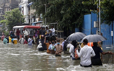 People walk through a water logged street after heavy rain in Mumbai, India, Wednesday, Sept. 23, 2020. (Photo | AP)