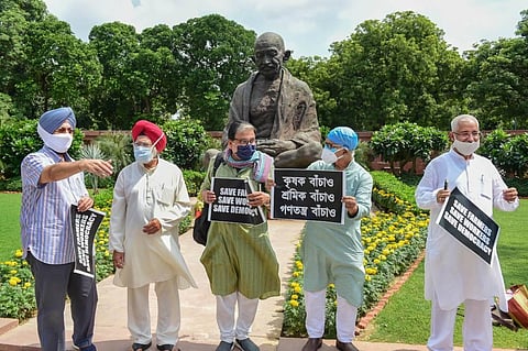 Congress MP Pratap Singh Bajwa, RJD MP Manoj Jha (C) and other opposition lawmakers march from Gandhi statue to Ambedkar statue in protest against the recent farm and labour bills. (Photo | PTI)