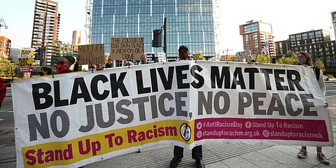 Protesters in front of the US flag flying outside the US Embassy in London, as part of an anti-racism demonstration. (File photo| AP)
