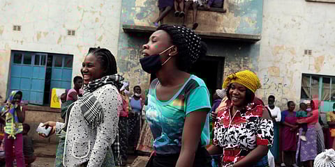 Women share a light moment while attending a social gathering in a poor neighbourhood in Mbare, Harare. (Photo| AP)
