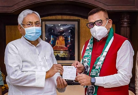 JD(U) National President and Bihar CM Nitish Kumar presents the membership slip to former DGP Gupteshwar Pandey as he joins the party in Patna on Sunday. (Photo | PTI)