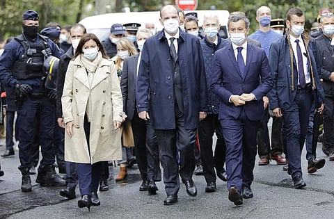 Paris mayor Anne Hidalgo, France PM Jean Castex, & Interior Minister Gerald Darmanin arrive on the scene after a knife attack near the former offices of satirical newspaper Charlie Hebdo. (Photo | AP)