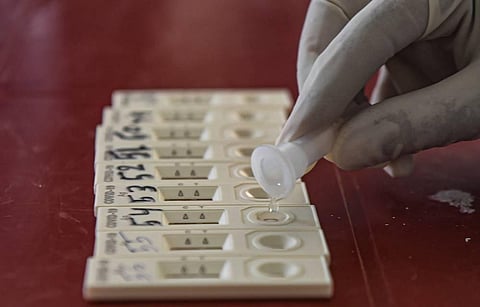 A health worker collects samples for COVID-19 Rapid Antigen test. (File photo | PTI)