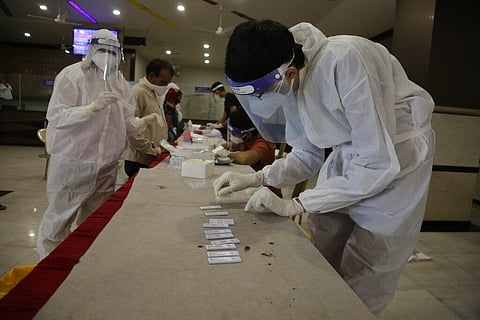 People stand in a queue to give their nasal swab samples to test for COVID-19 at a state transport bus station in Ahmedabad, India, Saturday, Aug. 29, 2020. (Photo | AP)