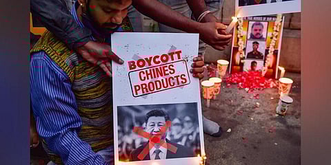 Citizens burn posters of Chinese President Xi Jinping after twenty Indian army personnel were martyred during a clash with Chinese troops in Ladakh's Galwan valley, during the ongoing COVID-19 nationw