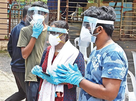 A family on its way to get tested for Covid-19, wearing masks, face shields and gloves, in Hyderabad on Wednesday | RVK Rao
