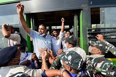 Congress activists raise slogans after being detained during a protest against the death of Dalit woman from Uttar Pradesh's Hathras. (Photo | PTI)