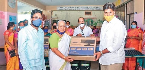 Staff of St Joseph’s Secondary School (SJSS) display one of the desktops donated by former MP from Nizamabad Kalvakuntla Kavitha on Friday