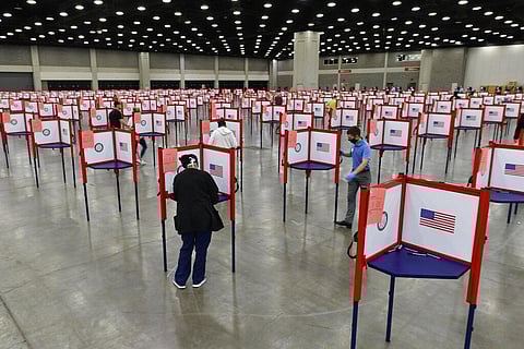 In this June 23, 2020, file photo voting stations are set up in the South Wing of the Kentucky Exposition Center for voters to cast their ballot in the Kentucky primary in Louisville, Ky. The November