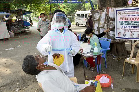 A health worker collects nasal swab near Victoria Hospital in Bengaluru. (Photo | EPS/Nagaraja Gadekal)