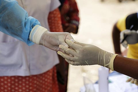 Health workers collect a nasal swab sample to test for COVID-19 in Ahmedabad, India, Sunday, Sept. 6, 2020. (Photo | AP)