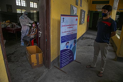 An Indian health worker takes a nasal swab sample of a woman to test for COVID-19 as a man waits for his turn in Gauhati, India, Sunday, Sept. 6, 2020. (Photo | AP)