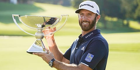 Dustin Johnson celebrates with the FedEx Cup trophy after winning the Tour Championship golf tournament. (Photo | AP)
