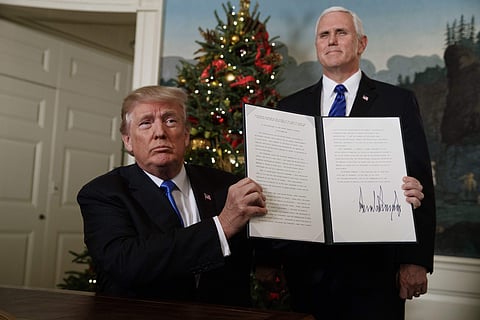 Vice President Mike Pence watches as President Donald Trump holds up a proclamation to officially recognize Jerusalem as the capital of Israel