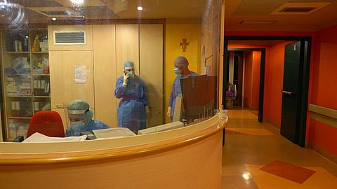 Medical personnel stand in the ward at Casalpalocco Covid 3 hospital in the outskirts of Rome, during the new year night. (Photo | AP)