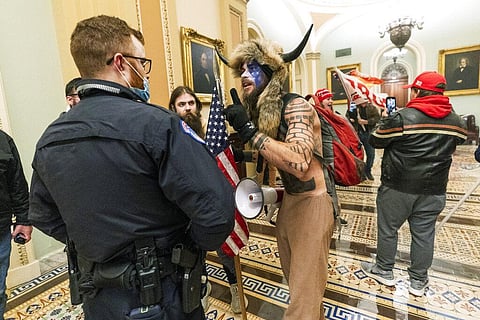 An Arizona man seen in photos and video of the mob wearing a fur hat with horns was also charged Saturday in Wednesday's chaos. (Photo | AP)
